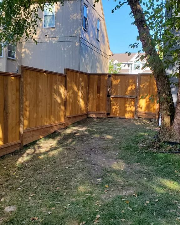 Stained cedar privacy fence with a matching gate